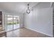 Bright dining area features tile flooring, backyard access through sliding glass doors, and a modern light fixture at 905 Smith St, Las Vegas, NV 89108
