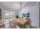 Bright dining area with modern light fixture, table setting, and sliding glass door to the yard at 905 Smith St, Las Vegas, NV 89108
