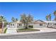 Charming single-story home with landscaped yard and palm trees against a blue sky at 905 Smith St, Las Vegas, NV 89108