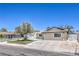 Beautiful home featuring a well-manicured front yard and spacious driveway under a bright blue sky at 905 Smith St, Las Vegas, NV 89108