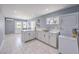 Bright kitchen features white cabinetry, modern appliances, and a window overlooking the backyard at 905 Smith St, Las Vegas, NV 89108
