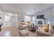 Bright living room with large window, tile flooring, fireplace, and neutral-colored furniture at 905 Smith St, Las Vegas, NV 89108