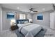 Comfortable bedroom with ceiling fan, picture window, and blue upholstered bed with side tables at 905 Smith St, Las Vegas, NV 89108