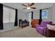 Bedroom with ceiling fan, neutral walls, plush carpet, modern crib and a purple arm chair at 9131 Grand Sunburst Ct, Las Vegas, NV 89149