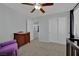 Bedroom with ceiling fan, neutral walls, plush carpet, closet and a purple arm chair at 9131 Grand Sunburst Ct, Las Vegas, NV 89149