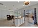 Open-concept dining area featuring a central island, dining table, and large windows at 9131 Grand Sunburst Ct, Las Vegas, NV 89149