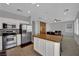 Spacious kitchen area with stainless steel appliances and an adjacent dining area at 9131 Grand Sunburst Ct, Las Vegas, NV 89149