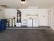 Spacious garage with washer and dryer, utility sink, and water filtration system at 9321 Lady Finger Ct, Las Vegas, NV 89149
