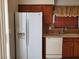 Kitchen area showcasing a refrigerator with a water dispenser and wooden cabinetry at 9321 Lady Finger Ct, Las Vegas, NV 89149