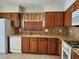 Functional kitchen featuring wood cabinets, tile backsplash, and modern appliances at 9321 Lady Finger Ct, Las Vegas, NV 89149