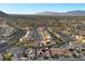 Suburban aerial view, highlighting tree-lined streets, lush green landscaping, and mountain backdrop at 9612 Glengarry Dr, Las Vegas, NV 89129