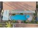 Backyard aerial view featuring a pool, hot tub, rock waterfall, patio, and landscaping at 9612 Glengarry Dr, Las Vegas, NV 89129