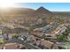 Expansive aerial view of a residential community with mountain backdrop and tiled roof homes at 9612 Glengarry Dr, Las Vegas, NV 89129