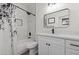 Bright bathroom featuring a shower-tub combo, white vanity, and modern fixtures at 9612 Glengarry Dr, Las Vegas, NV 89129