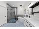A stunning bathroom with a glass-enclosed shower, freestanding tub, and stylish blue-patterned tile flooring at 9612 Glengarry Dr, Las Vegas, NV 89129