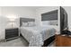 Well-lit bedroom showcases modern furnishings, including a gray headboard, side table, and mounted TV at 9612 Glengarry Dr, Las Vegas, NV 89129