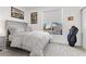 Cozy bedroom with patterned bedding, window view, and decor; showcasing a comfortable and bright space at 9612 Glengarry Dr, Las Vegas, NV 89129