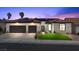 Charming home featuring a two-car garage, tile roof, solar panels, and well-manicured lawn at 9612 Glengarry Dr, Las Vegas, NV 89129