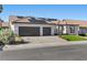 Charming home featuring a two-car garage, tile roof, solar panels, and well-manicured lawn at 9612 Glengarry Dr, Las Vegas, NV 89129
