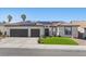 Charming home featuring a two-car garage, tile roof, solar panels, and well-manicured lawn at 9612 Glengarry Dr, Las Vegas, NV 89129