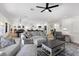 Open-concept living room featuring stylish furniture, a coffee table, and hardwood floors extending into the kitchen at 9612 Glengarry Dr, Las Vegas, NV 89129