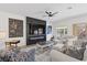 Comfortable living room with a fireplace, large screen TV, and stylish furnishings and access to the backyard at 9612 Glengarry Dr, Las Vegas, NV 89129