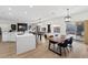 Open concept living room featuring a kitchen island, billiard table, and dining table with backyard access at 9612 Glengarry Dr, Las Vegas, NV 89129