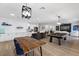 Open concept kitchen and living room featuring modern white cabinetry and a billiard table for recreation at 9612 Glengarry Dr, Las Vegas, NV 89129
