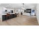 Open-concept living space connecting the kitchen, living room, and backyard featuring modern lighting and flooring at 9612 Glengarry Dr, Las Vegas, NV 89129