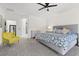 Bright bedroom featuring neutral tones, a king-sized bed, and a glimpse of a stylish bathroom through the doorway at 9612 Glengarry Dr, Las Vegas, NV 89129