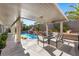 Enjoy outdoor relaxation beneath the covered patio, with a view of the rock waterfall pool feature at 9612 Glengarry Dr, Las Vegas, NV 89129