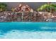 Tranquil pool featuring a rock waterfall and lush landscaping for a serene outdoor escape at 9612 Glengarry Dr, Las Vegas, NV 89129