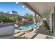 Entertain in style with a covered patio, pool, rock waterfall, and a soothing jacuzzi at 9612 Glengarry Dr, Las Vegas, NV 89129