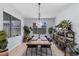 Bright dining room with a wooden table, modern chairs, and decorative plants at 9785 Granite Mesa St, Las Vegas, NV 89141