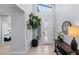 Bright foyer with tile flooring, decorative plants, and a view into another room at 9785 Granite Mesa St, Las Vegas, NV 89141