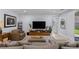 A comfortable living room with neutral tones, an area rug, and a large TV at 9785 Granite Mesa St, Las Vegas, NV 89141