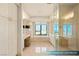 Bright bathroom featuring a soaking tub, walk-in shower, and city views at 1 Hughes Center Dr # 903, Las Vegas, NV 89169