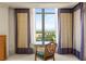 Desk area set up overlooking the city, framed by floor to ceiling windows and stylish curtains at 1 Hughes Center Dr # 903, Las Vegas, NV 89169
