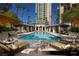 Upscale community pool with plenty of lounge seating surrounded by mature landscaping at 1 Hughes Center Dr # 903, Las Vegas, NV 89169