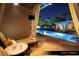 Relaxing pool cabana featuring comfortable seating and a view of the pool at night at 1 Hughes Center Dr # 903, Las Vegas, NV 89169