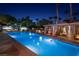 A night shot of the community pool with palm trees and bright blue water at 1 Hughes Center Dr # 903, Las Vegas, NV 89169