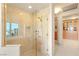Glass enclosed shower with gold hardware and a view of the city skyline at 1 Hughes Center Dr # 903, Las Vegas, NV 89169