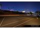 Well maintained tennis court with dark green surface and tall perimeter fencing at 1 Hughes Center Dr # 903, Las Vegas, NV 89169