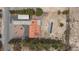 Aerial view displays a desert landscape featuring a house with a red tile roof and an open carport at 1050 Morgan Ln, Pahrump, NV 89060