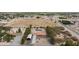 Aerial view showcases this homes sprawling lot with desert vegetation, solar panels, and nearby road at 1050 Morgan Ln, Pahrump, NV 89060