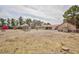 Expansive backyard features a shed, solar panels, play structure, and a large carport at 1050 Morgan Ln, Pahrump, NV 89060