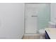 Bathroom featuring a shower with sliding glass doors, white tiling, grab bars, and a matching toilet at 1050 Morgan Ln, Pahrump, NV 89060