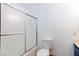 Standard bathroom featuring a shower-tub combo with sliding glass doors, toilet, and an outlet at 1050 Morgan Ln, Pahrump, NV 89060