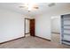 Neutral bedroom with carpet, ceiling fan, and a mirrored closet with sliding doors at 1050 Morgan Ln, Pahrump, NV 89060