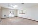Sunlit bedroom with skylight, French doors, window, and neutral carpet and walls at 1050 Morgan Ln, Pahrump, NV 89060